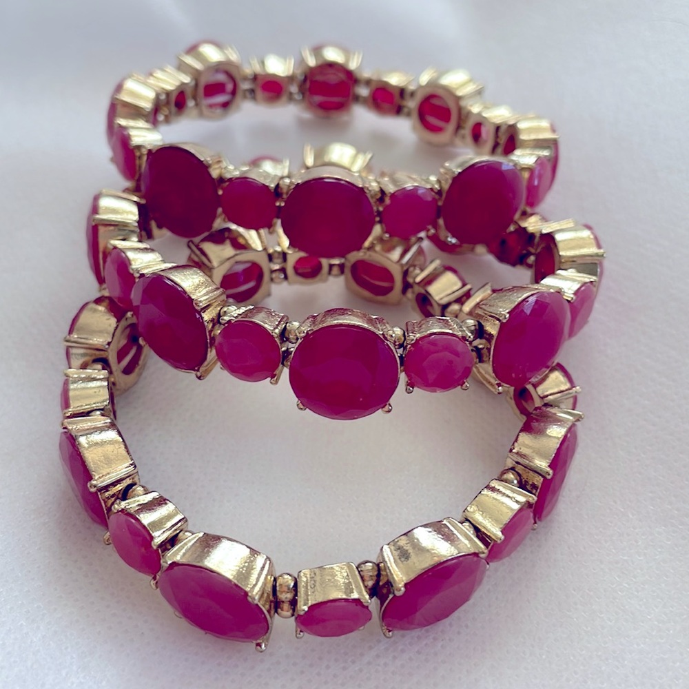 3 Pink Stone stretch bracelets with gold trim.